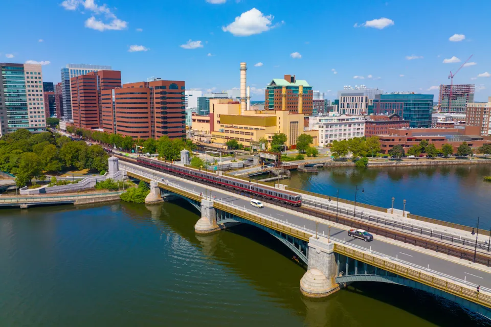 Cambridge Kendall Square skyline and MBTA red line train on Longfellow Bridge aerial view, Boston, Massachusetts MA, USA.